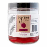 Jar of Supreme Vinegar with a red label on a white background