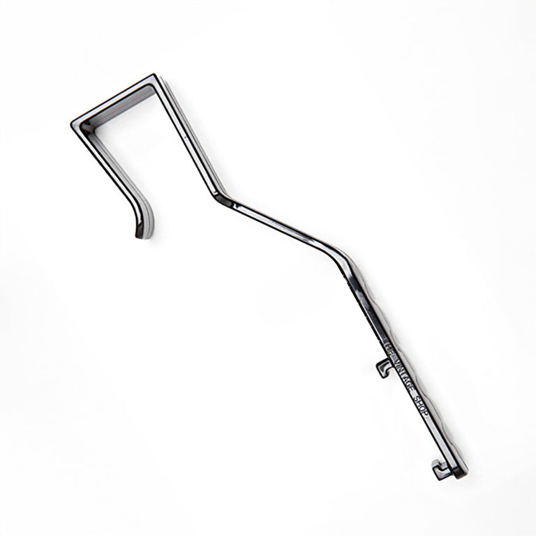 Black plastic tool with a angled handle on a white background