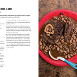 Red plate with beef shanks and cranberry beans on a wooden surface, accompanied by text on the left.
