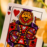 Card with a colorful king of hearts as a lion design, surrounded by flowers.