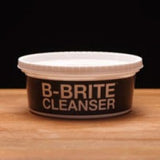 Brite Cleanser container on a wooden surface with a black background