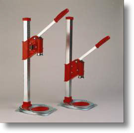 Two red and silver stand-up beer cappers on a gray background