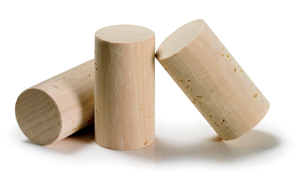 Three wooden wine bottle corks on a white background