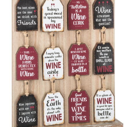 Decorative wall art with wine-themed sayings on wooden tags.