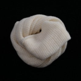 White knitted Muslin bag coiled on a black background