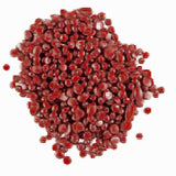 Red wax pellets on a white background