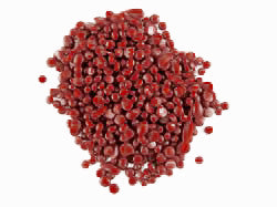 Red wax pellets on a white background
