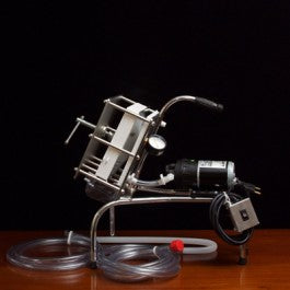 Metallic Filter unit tool on a wooden surface with a dark background