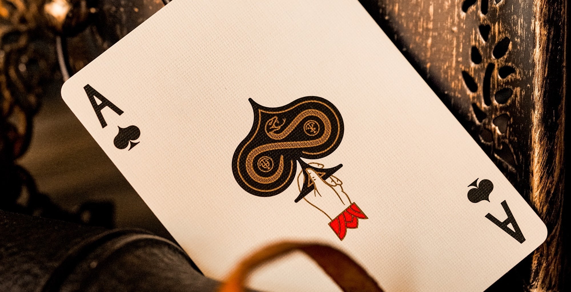 Playing card with ace of spades on a wooden surface