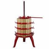 Wooden fruit press with red metal frame on a white background