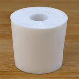 White rubber bottle stopper with hole on a wooden background