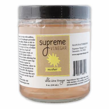 Jar of Supreme Vinegar with a label on a white background