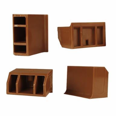 Four brown plastic corker jaws on a white background