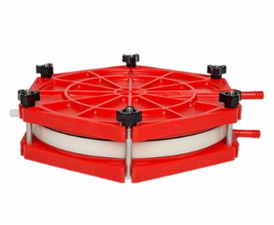 Red plastic filter with a hexagonal base and circular top on a white background