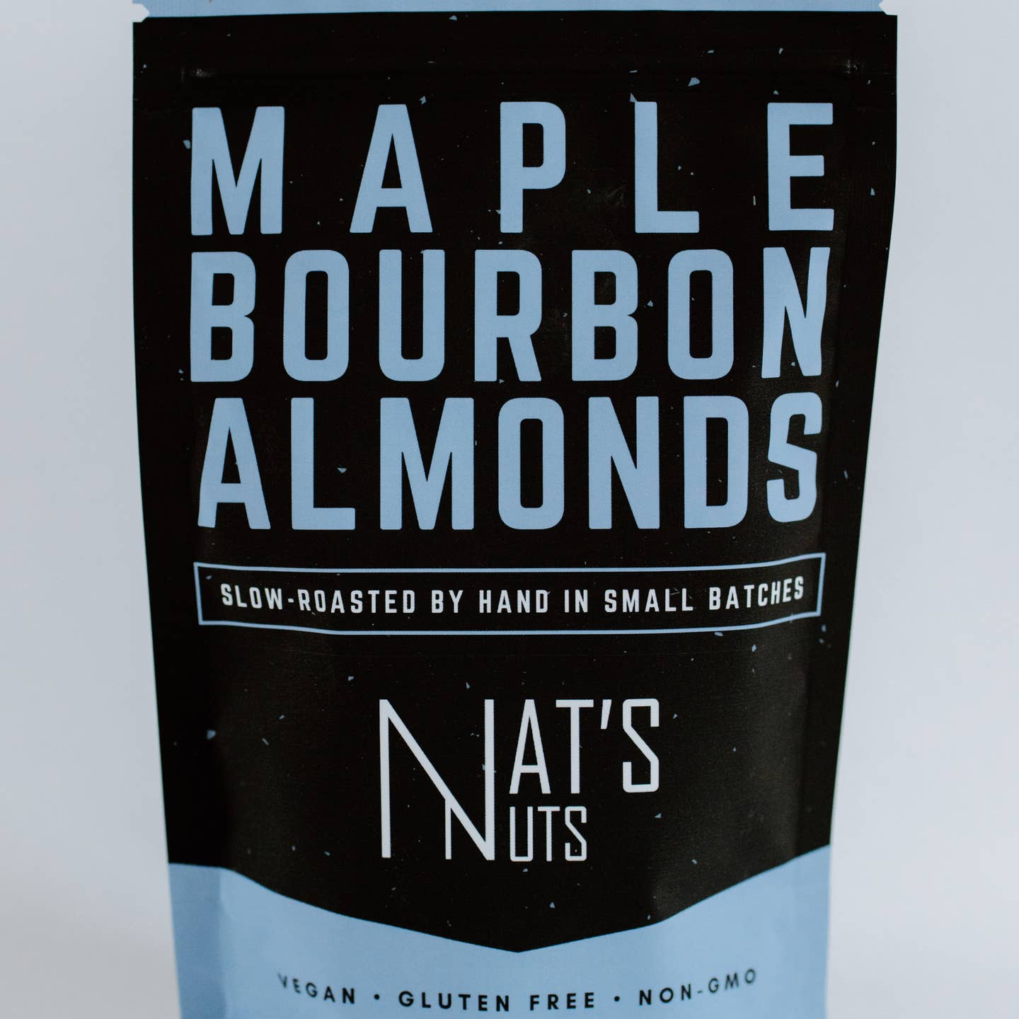Packaging of Maple Bourbon Almonds from Nat's Nuts with black and blue design.