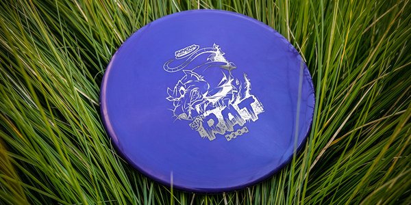 Purple Rat disc golf disc with white text and graphics on grass