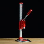 Red and white cappertool on a wooden surface with a black background