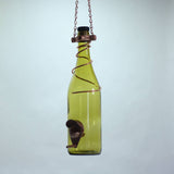 Green glass bottle repurposed as a hanging bird feeder on a plain background